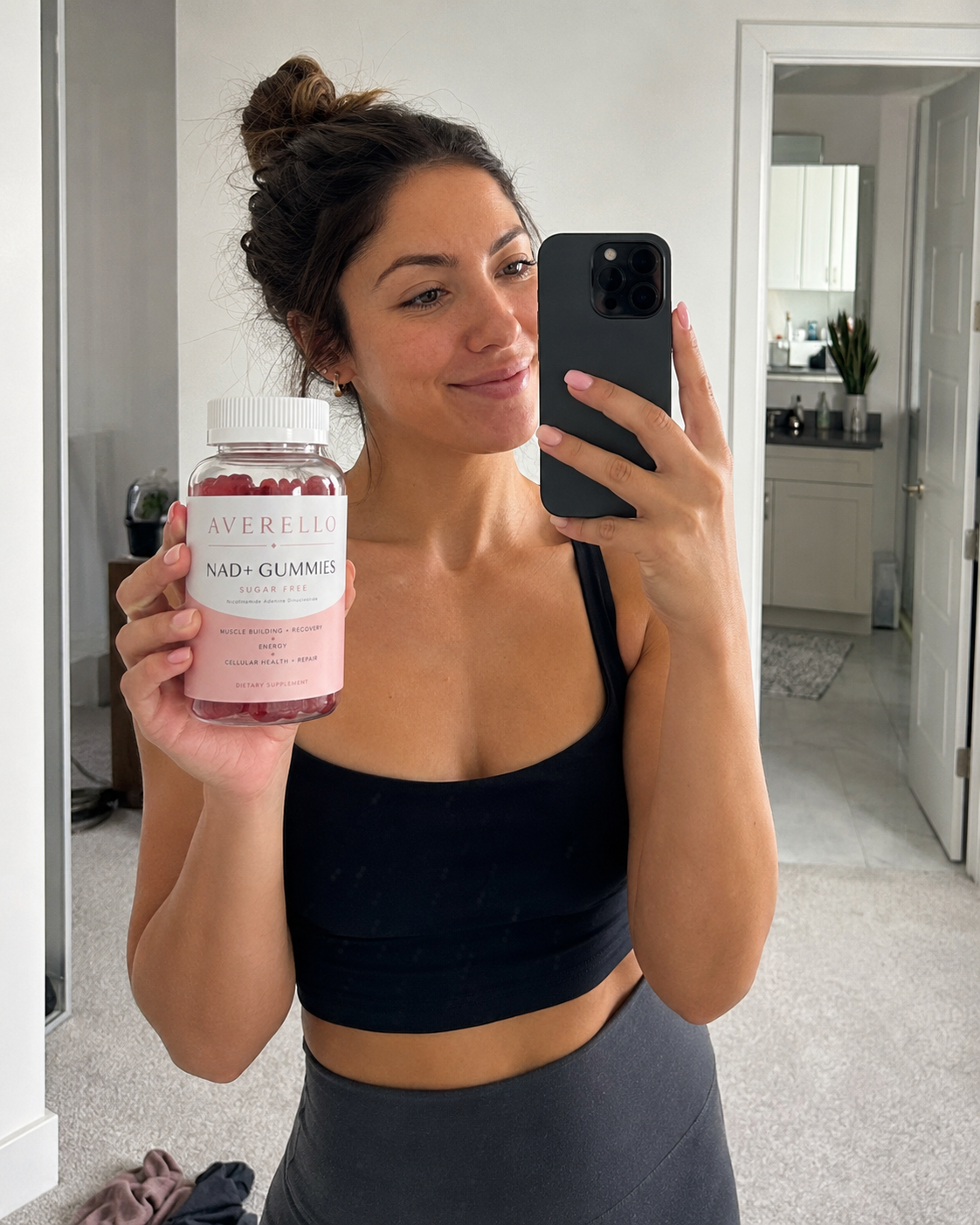 Mia R. holding a bottle of Averello NAD+ Gummies