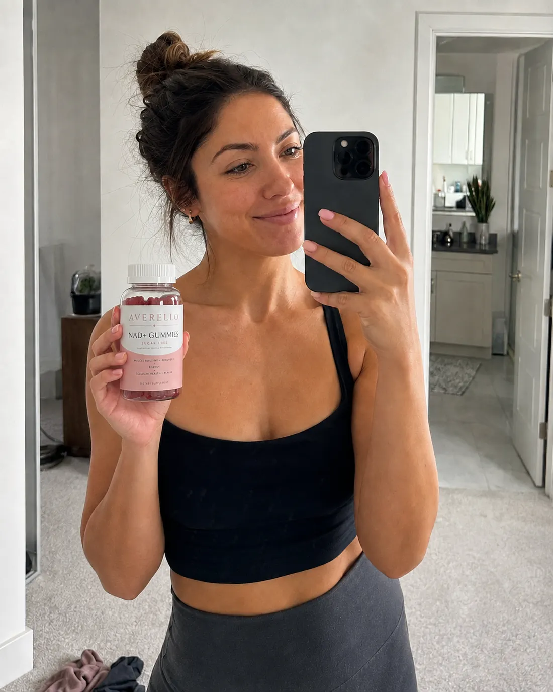 Mia R. holding a bottle of Averello NAD+ Gummies